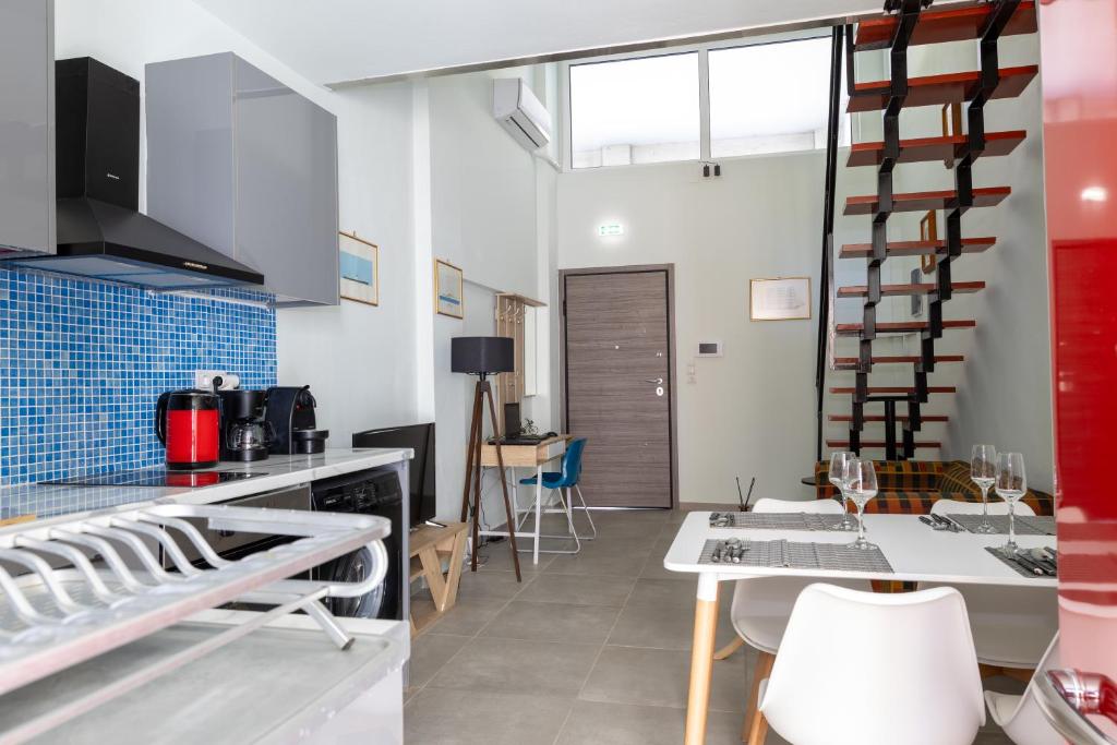 The kitchen with its blue-tiled splashback, coffee corner and dining table